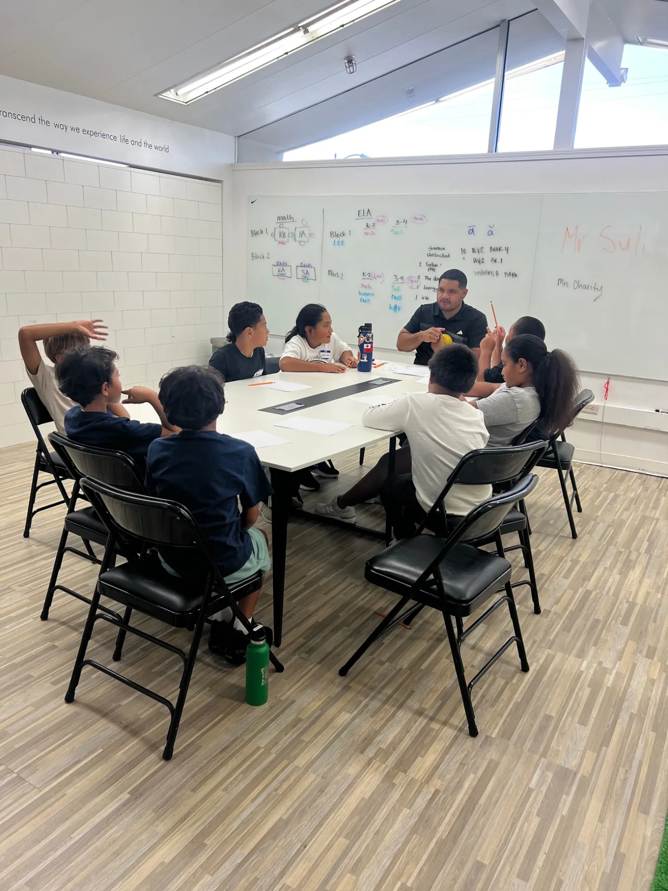 Students participating in a small-group classroom discussion