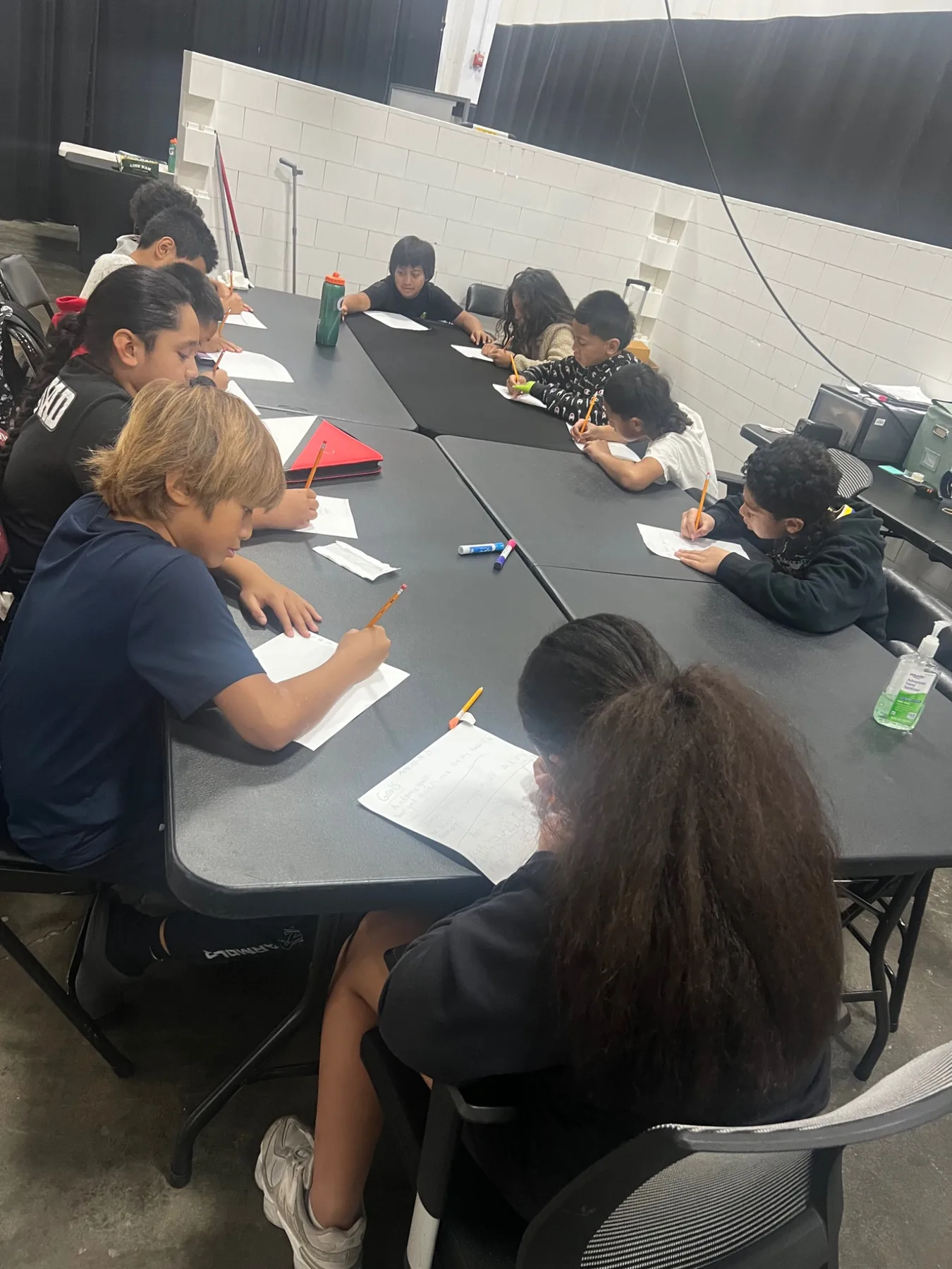 Students completing focused academic work around a table